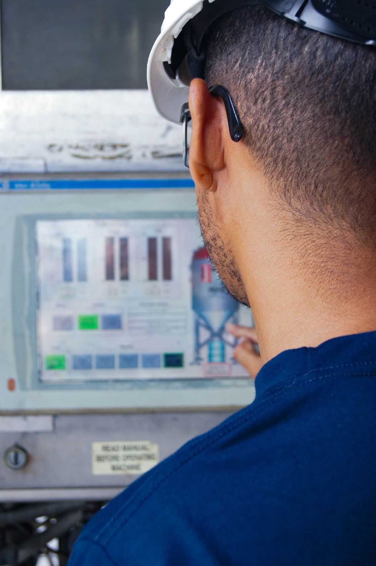 Plant engineer operating an industrial MES control panel